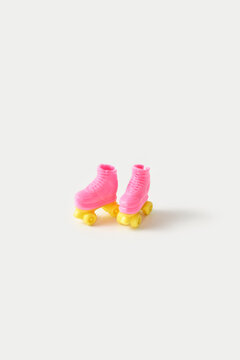 Miniature pair of doll rollers standing on grey background