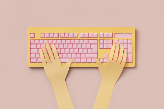 Papercraft human hands typing on colorful computer keyboard