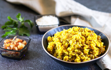 Traditional Middle Eastern dish, Mujadara on dark background with light textiles