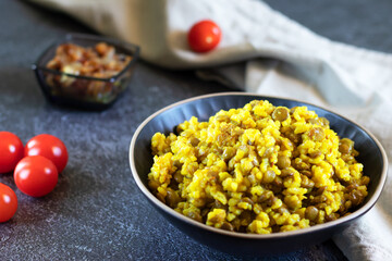 Middle Eastern dish, Mujadara of lentils, rice, fried onions on dark background