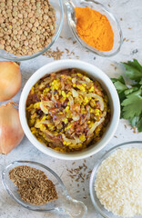 Ingredients for the Middle Eastern dish mujadara on light background top veew