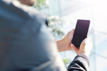 Adult man looking on cell phone