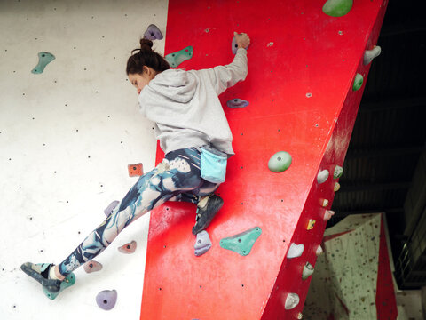 Woman training on indoor climbing wall 