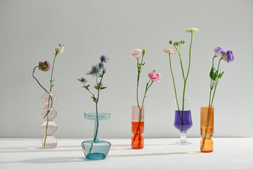 Glass vases with beautiful bouquets of fresh flowers