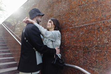Young couple embracing on stairs in empty place