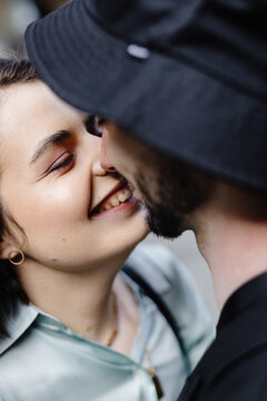 Engaged couple toching by faces and smiling to each other