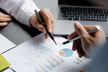 Naklejka premium Two businessmen pointed to the material for the meeting, working together to plan to develop and solve common business problems. Concept of business management for growth and quality.