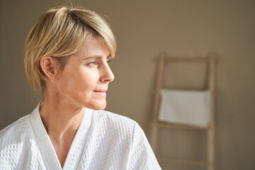 Middle aged woman looking away during spa session