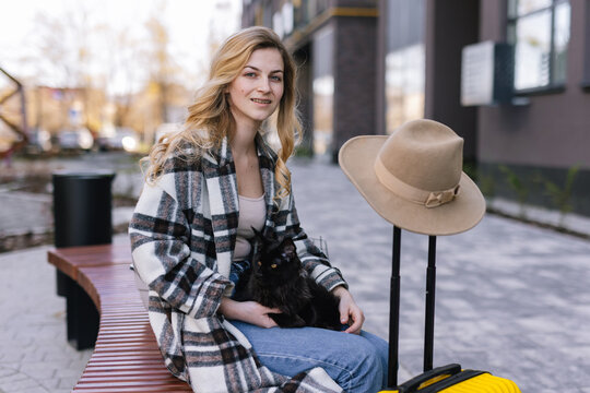 Female traveler taking short breather with pet 