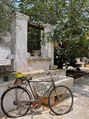 Alberobello, Italy, Apulia region Trullo buildings, bicycle parked next to an old horse trough