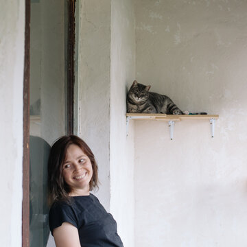 Young woman with cat at home