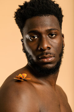 Black man studio portrait posing with butterfly