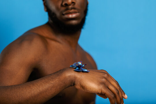 Butterfly perched on black man's hand