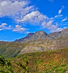 Beautiful mountain in peaceful rocky land on a sunny day in Cape Town. Vibrant land with lush green bushes and plants growing with harmony in nature. Relaxing, soothing views of South Africa