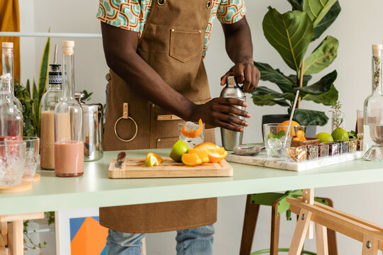 Crop Mixologist Using Cocktail Shaker