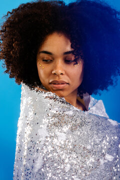 Attractive woman posing with sequined cloth