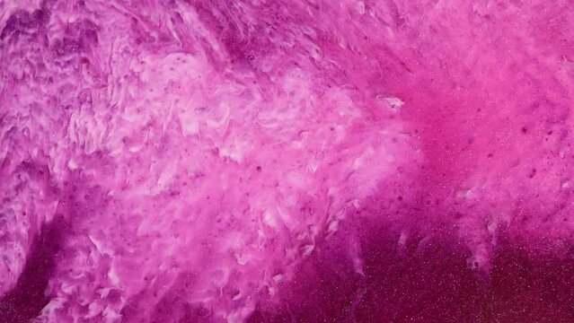 Abstract liquid art background. Flows and overflows of rich colored pink paint. Fluid spills.