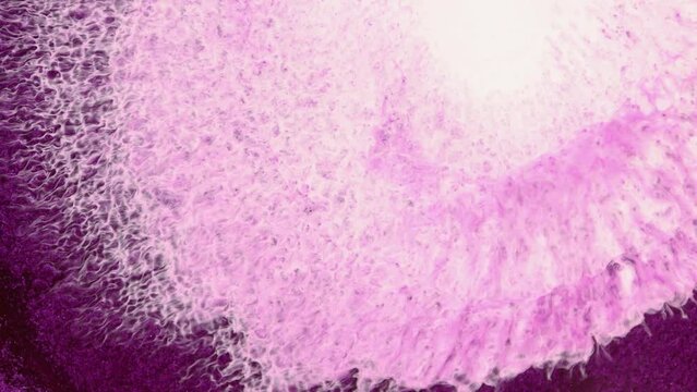 Bright abstract fluid art background. Spills of rich fuchsia color paint. Fantasy pink white foam and waves in vivid purple liquid.