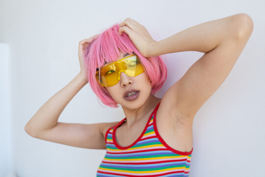 Trendy Asian female in yellow sunglasses