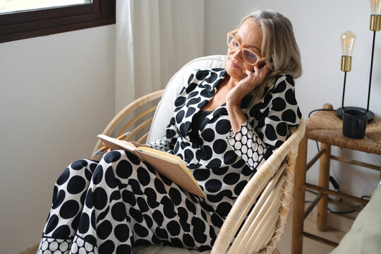 Senior Woman Making Phone Call From Bedroom