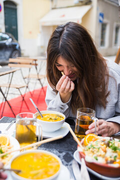 Woman enjoying meal on a terrace outdoors