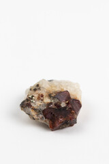 Rough Natural Garnet stone in Matrix. Mineralogy Collection specimen on white background