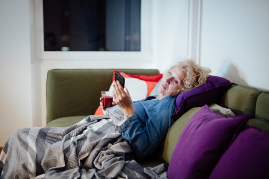 Woman at home using mobile phone