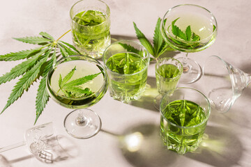 SBD hemp drink in various glasses, light concrete background hard shadow, energy cocktail cannabis