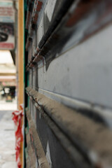 Close up view of closed shop roll with graffiti on it
