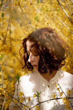 Woman Surrounded By Blooming Forsythia
