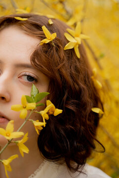 Woman Surrounded By Blooming Forsythia