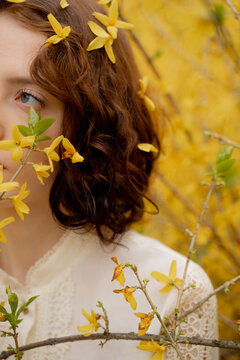 Woman Surrounded By Blooming Forsythia
