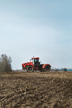 Tractor on plowed field in farmland