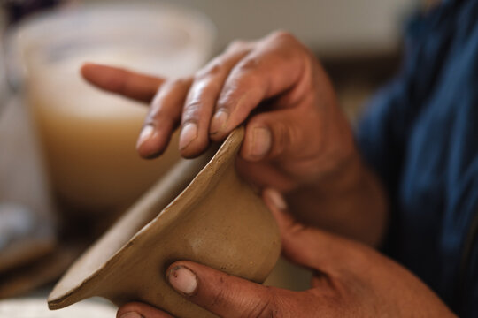 closeup of Artisan  hands Shaping a piece of clay 