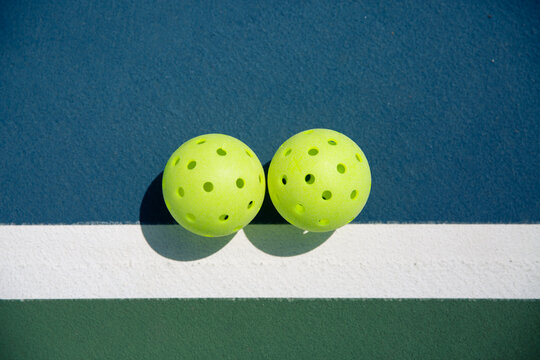 Lime Green Pickleballs on Court