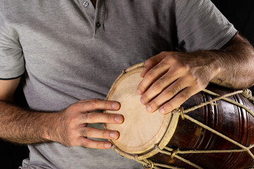 Man playing with his fingers on a hand drum