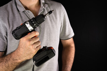 Cordless drill screwdriver in the hands of a man