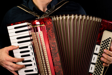 Man playing accordion with two hands - obrazy, fototapety, plakaty