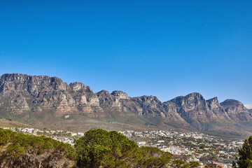 Beautiful mountain panorama with a clear blue sky and urban city with copy space in South Africa. Wide angle view of The twelve apostles with houses and trees, popular landmark and travel location