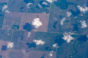 Aerial view of the midwest United States featuring farms in Minnesota as seen through clouds