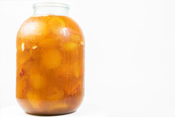 Jar with apricot jam isolated on white background