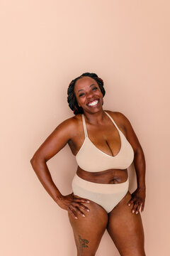 Radiant black woman posing in underwear