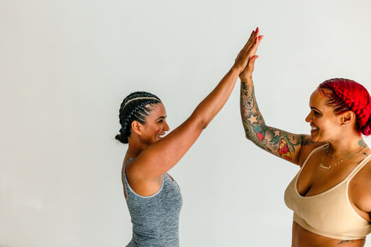 Female friends high-fiving in studio