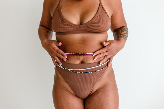 Female in underwear holding beads