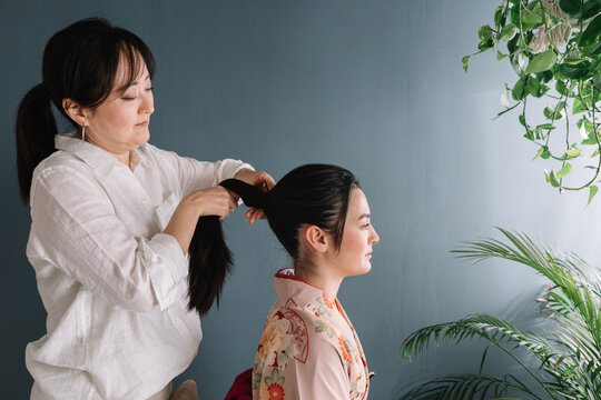 Mother Doing Daughter's Hair