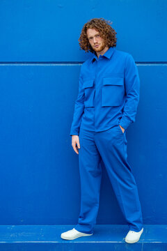 Confident man in blue clothes standing on border