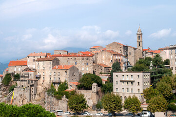 Old buildings of the town of Sartene on the island of Corsica in France. Town with houses and church tower in the mountains.