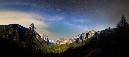 Yosemite near sunrise with milky way and clouds over valley
