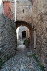 Fototapeta na wymiar Sant Antonino, France - 06 August 2012: Narrow old stone streets in the small mountain town of Sant'Antonio on the island of Corsica