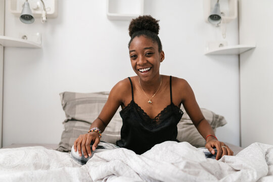 African American teenager on bed in morning